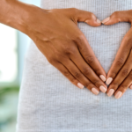 woman holding stomach for gut health